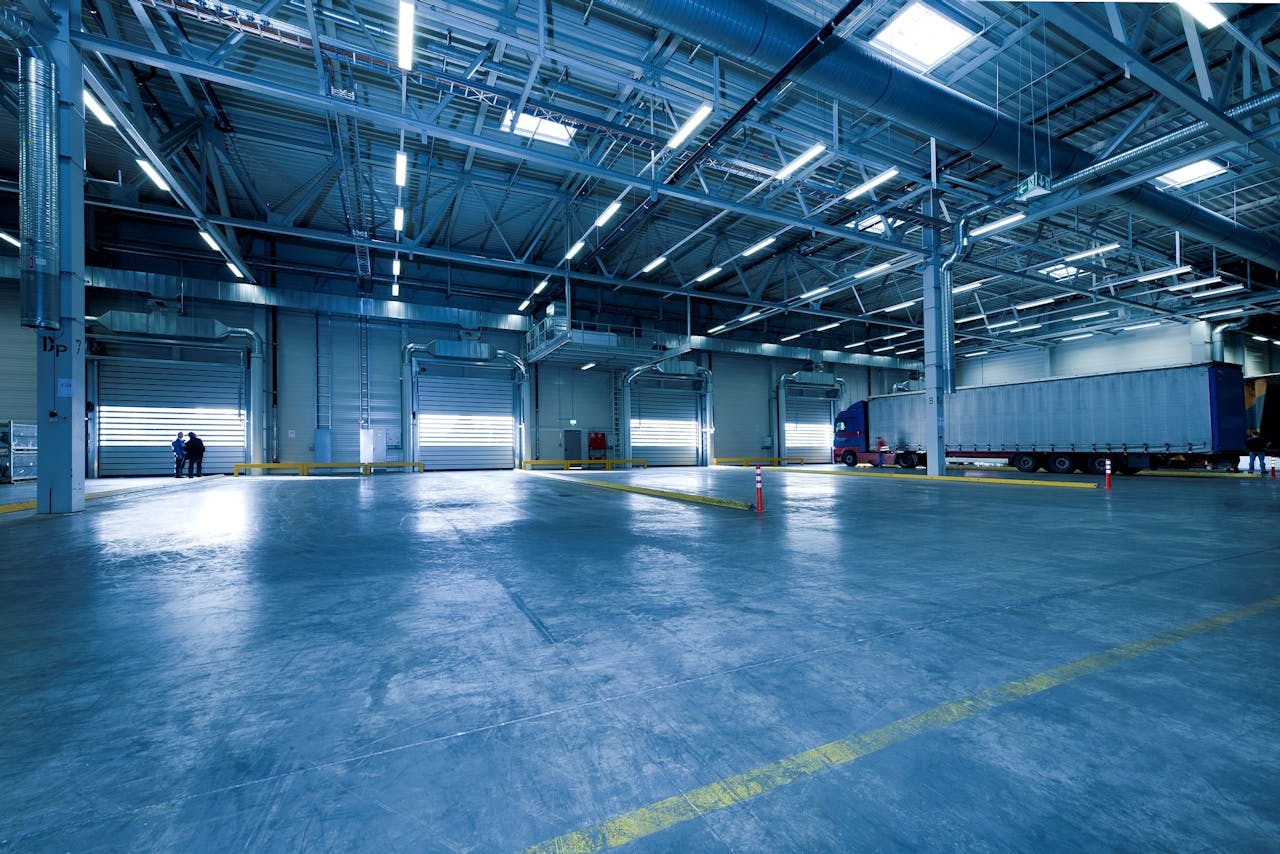 creative Large warehouse interior with docked truck, ideal for logistics and warehousing.